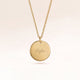 Personalized round gold necklace with space for engraving of text, coordinates or handwriting on the front and back