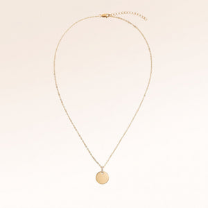 Full round gold necklace with white zirconia laid out flat with a fine adjustable gold chain and round pendant for personalised engraving