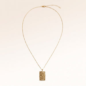 The full rectangular gold necklace with a soft melted look laid out, with a fine adjustable gold chain and a pendant for personal engraving