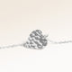 Close-up of minimalist heart-shaped heart pendant in silver with rippled wave surface and space for engraving on back